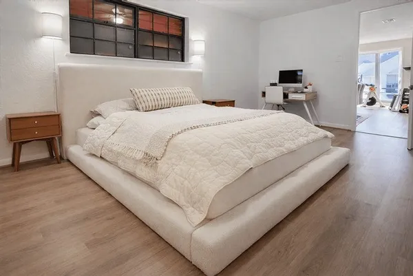 a large white bed in a white room