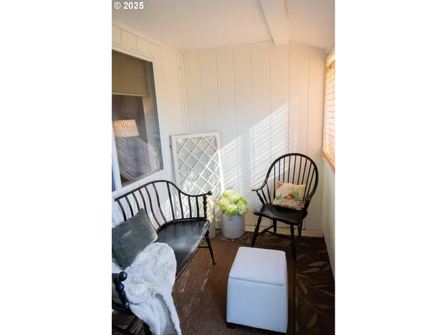a view of a hallway with chairs and a large window