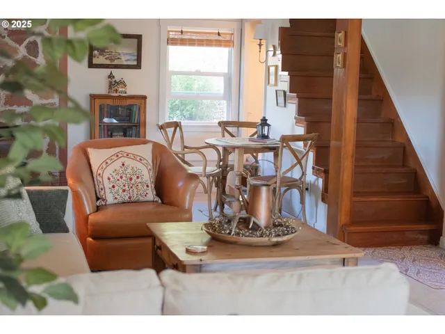 a view of kitchen with stainless steel appliances kitchen island granite countertop furniture and a fireplace