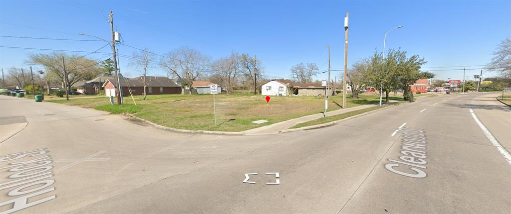 View of road featuring sidewalks, traffic signs, street lighting, and curbs