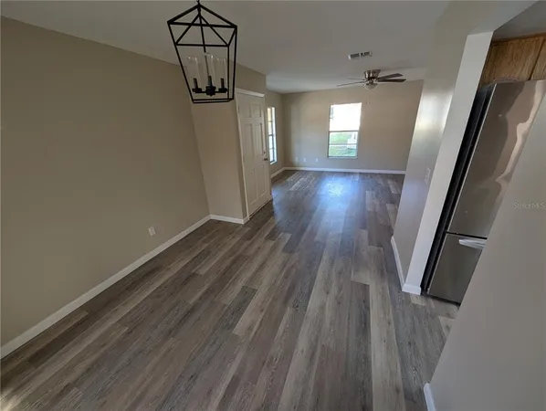 a view of a hallway view with wooden floor