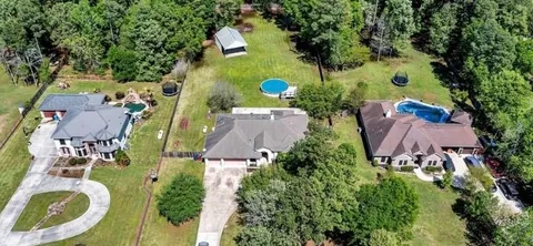 an aerial view of a house with outdoor space pool seating area and yard