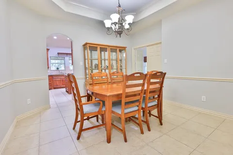 a spacious bedroom with a bed and a dresser