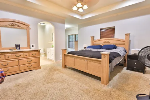 a spacious bathroom with a double vanity sink a mirror and a shower