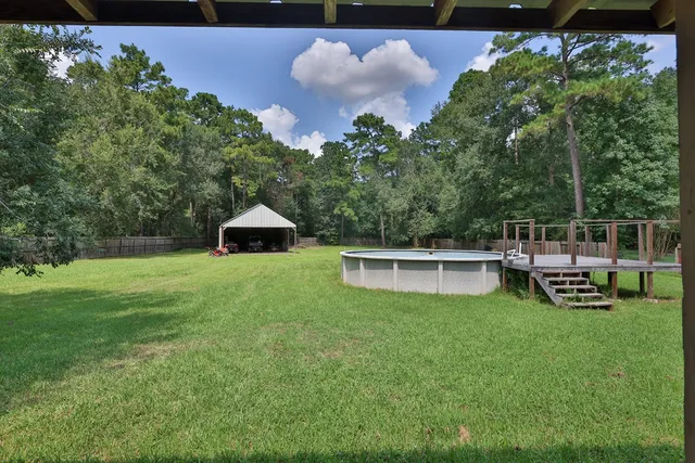a view of a chair and table in backyard of the house
