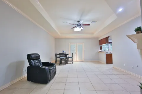 a living room with furniture a fireplace and a chandelier