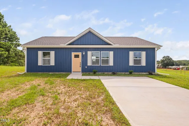 a front view of a house with yard