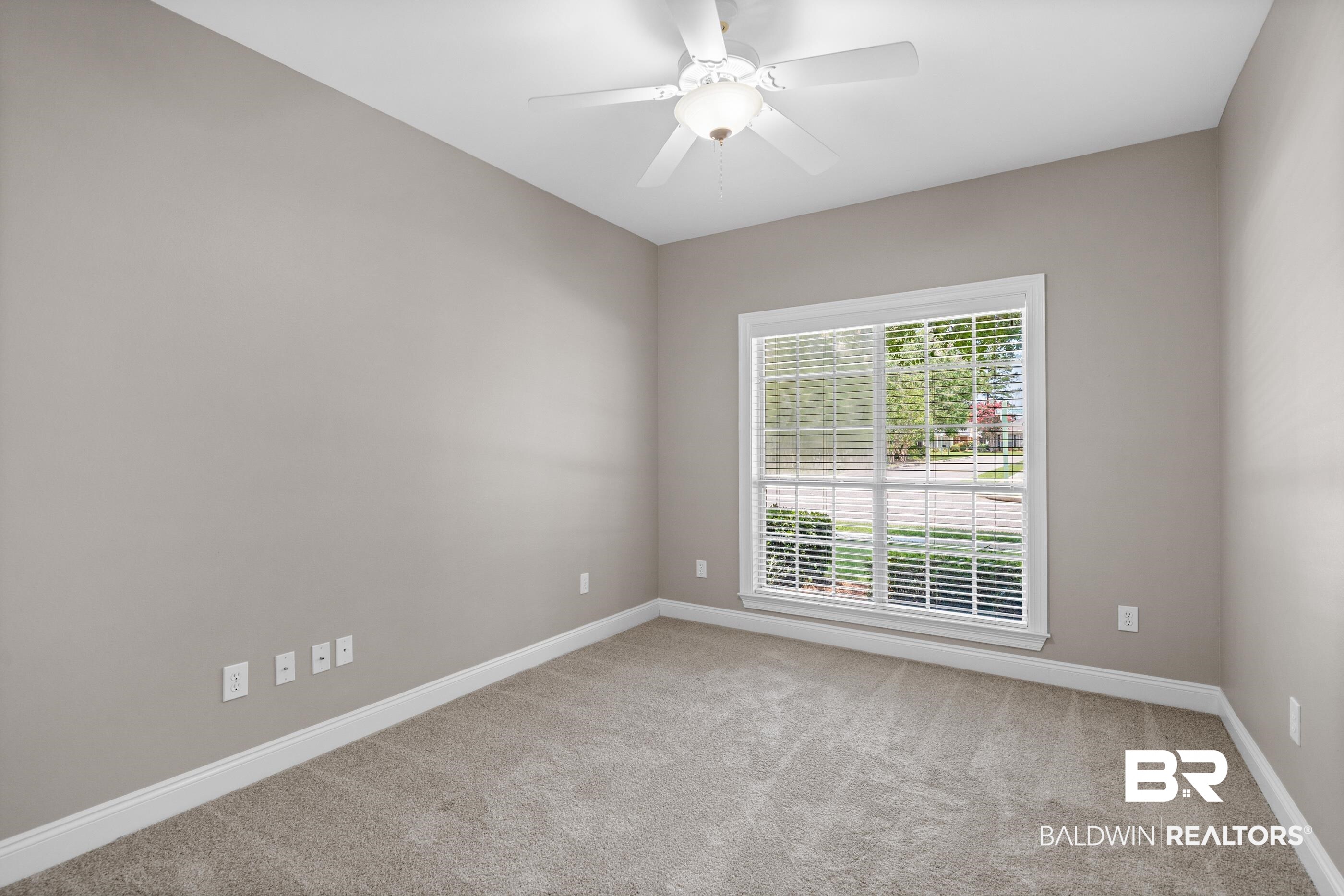 303 Savannah Circle Foley, AL 36535 - Photo 15 of 34 Light gray walls with white baseboards and neutral carpeting