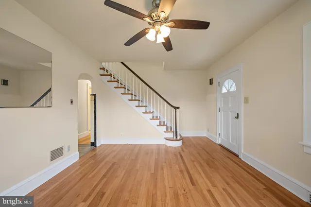 a view of entryway and hall with wooden floor