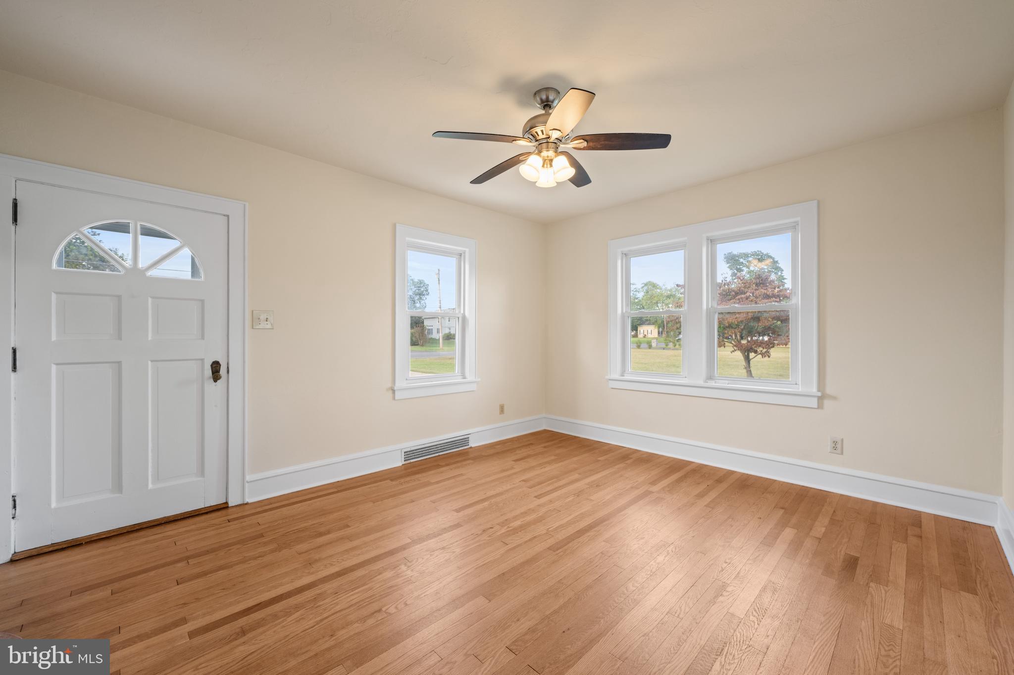 1547 East Wheat Road Vineland, NJ 08360 - Photo 15 of 32 a view of an empty room with a window and wooden floor