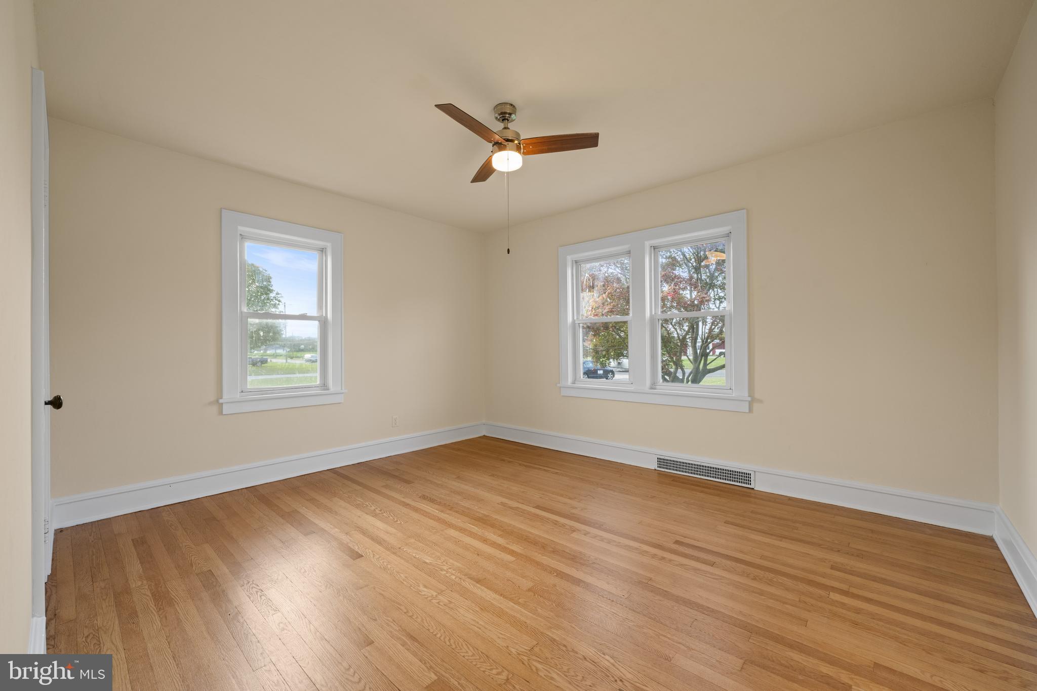 1547 East Wheat Road Vineland, NJ 08360 - Photo 21 of 32 a view of an empty room with wooden floor and a window