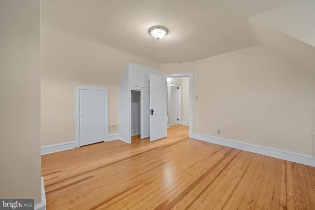 a big room with wooden floor and natural light