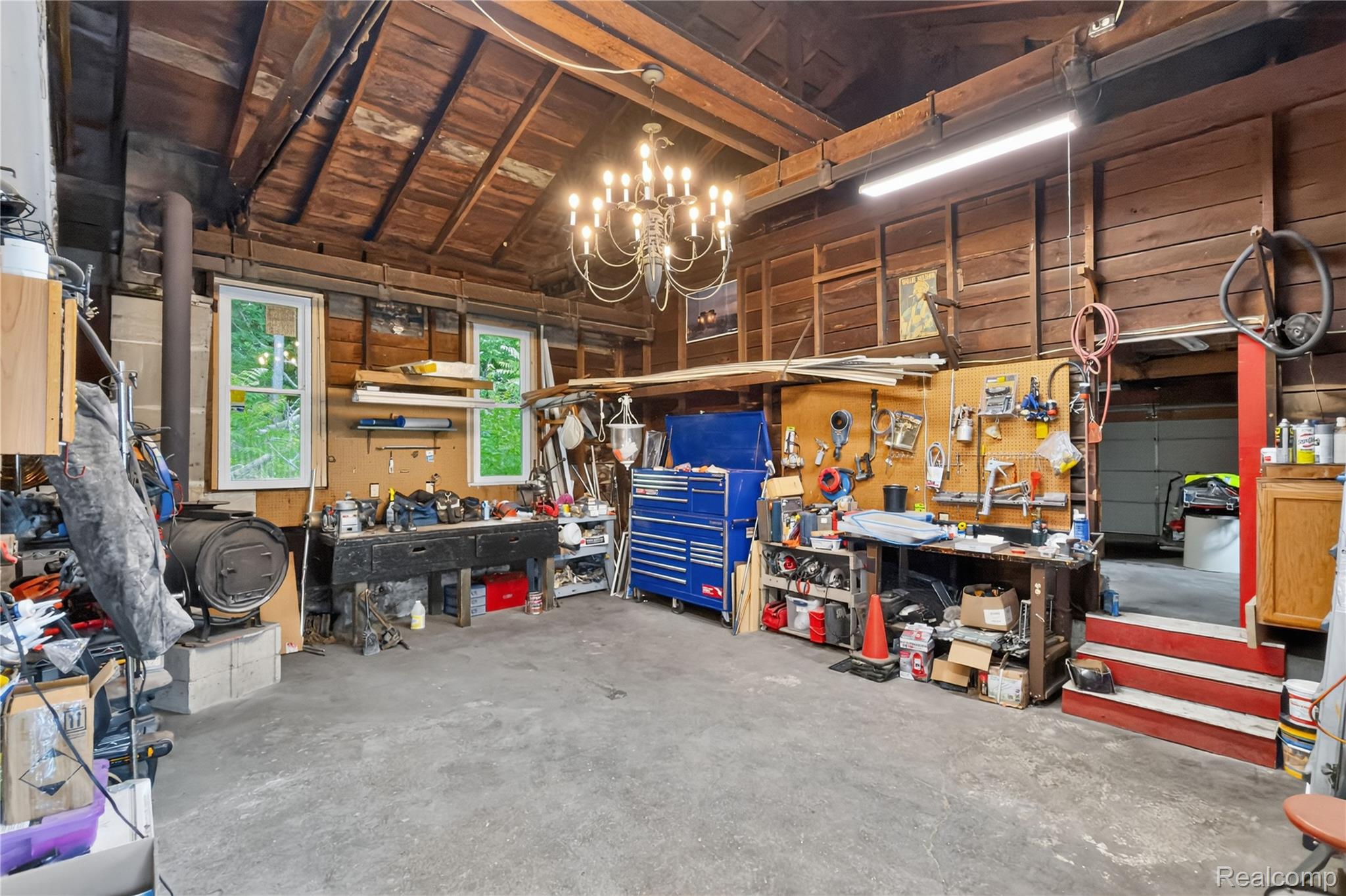 4860 Blue Bush Road Monroe, MI 48162 - Photo 45 of 59 Spacious workshop featuring exposed wood ceiling beams, concrete flooring, and multiple windows providing natural light