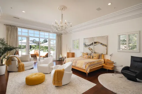 a bedroom with furniture and a large window