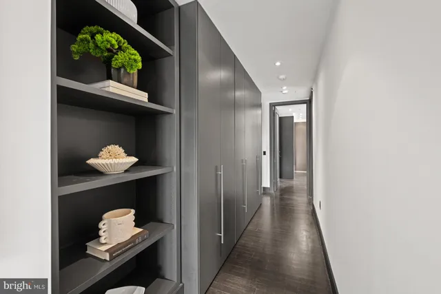 a bedroom with a large bed and wooden floor