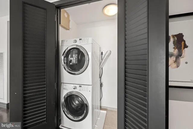 a view of a hallway with wooden floor windows and a livingroom
