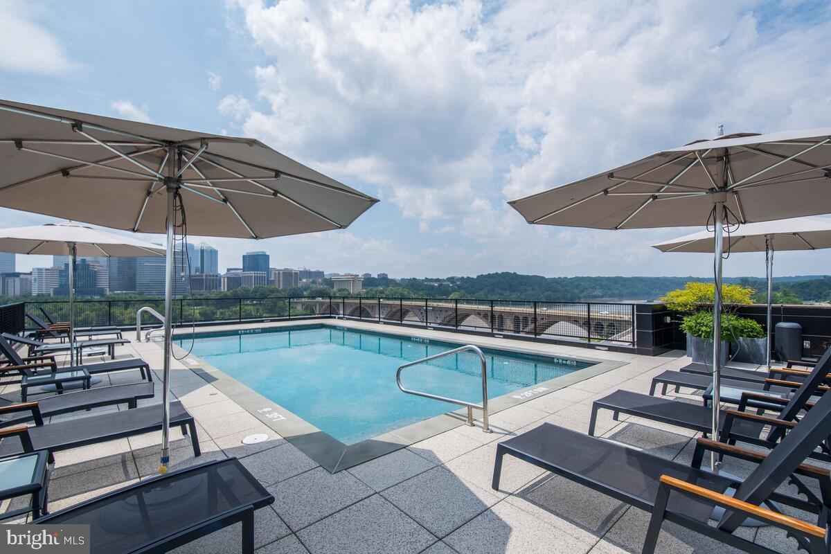 3303 Water Street Northwest, Unit 7E Washington, DC 20007 - Photo 23 of 29 a view of a swimming pool with sitting area