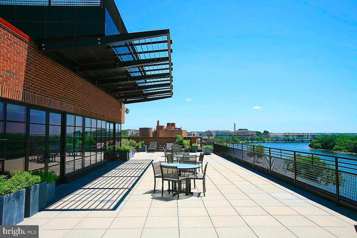 3303 Water Street Northwest, Unit 7E Washington, DC 20007 - Photo 24 of 29 a view of a patio with a table and chairs