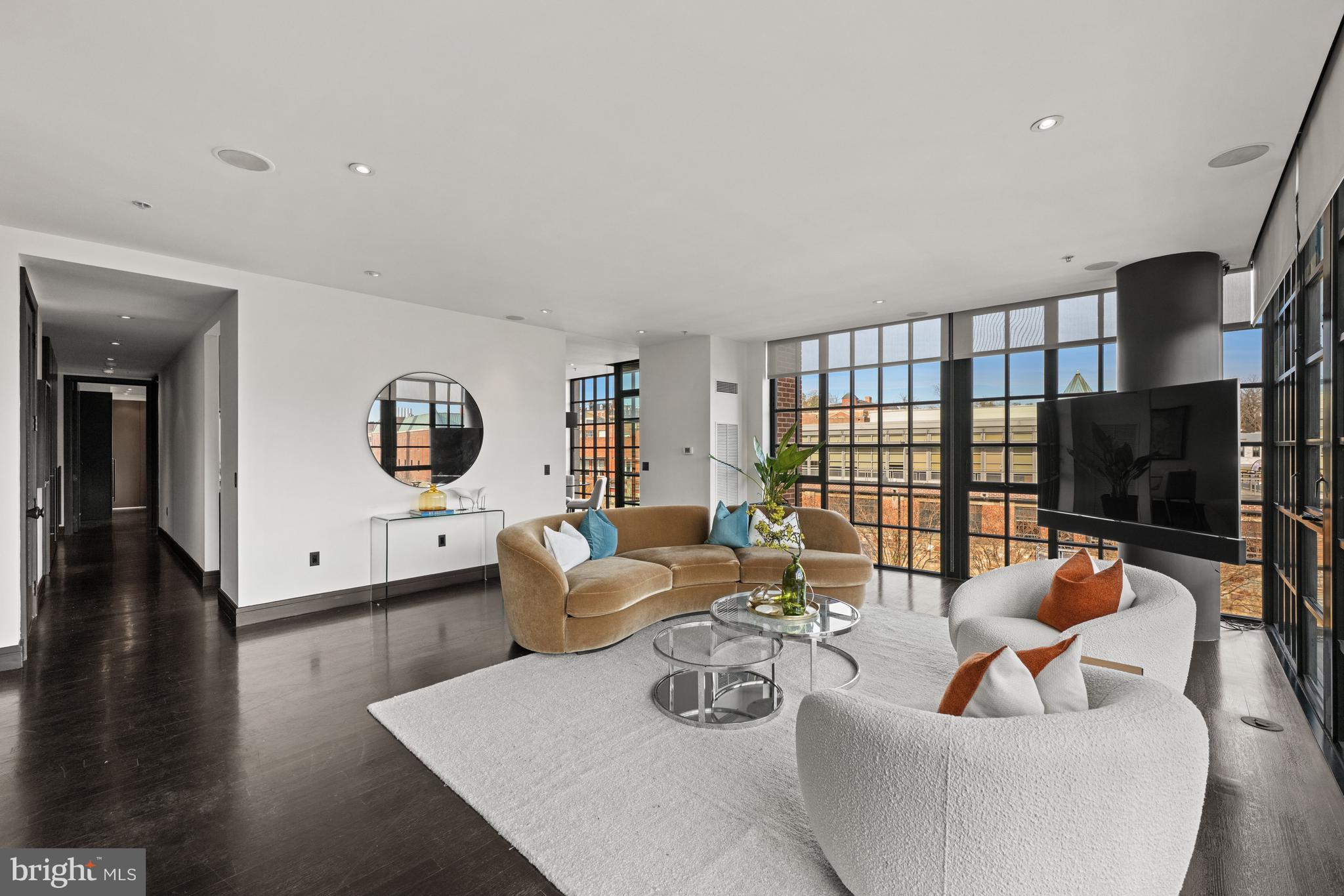 3303 Water Street Northwest, Unit 7E Washington, DC 20007 - Photo 7 of 29 a living room with furniture and a flat screen tv
