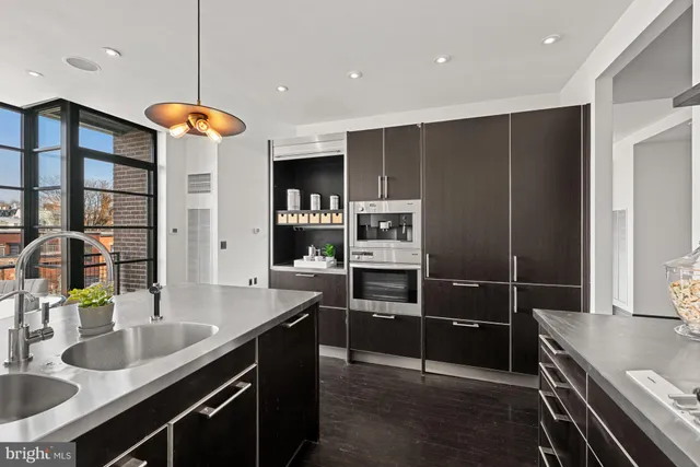a kitchen with stainless steel appliances granite countertop a stove a sink and a refrigerator