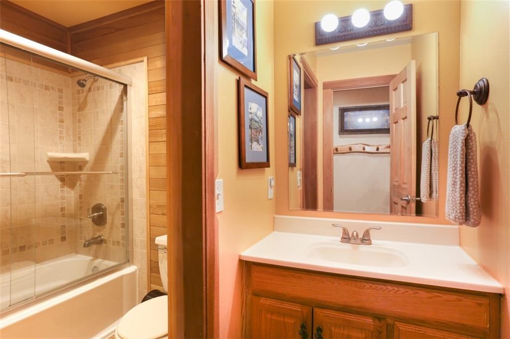 1080 Ski Hill Road, Unit 9 Breckenridge, CO 80424 - Photo 19 of 25 a bathroom with a granite countertop sink and a mirror
