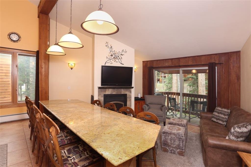 1080 Ski Hill Road, Unit 9 Breckenridge, CO 80424 - Photo 3 of 25 a living room with furniture a flat screen tv and a large window