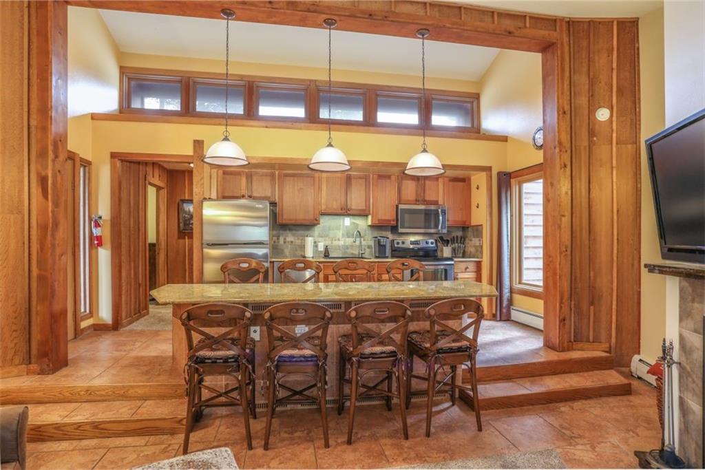 1080 Ski Hill Road, Unit 9 Breckenridge, CO 80424 - Photo 5 of 25 a dining table with chairs and window