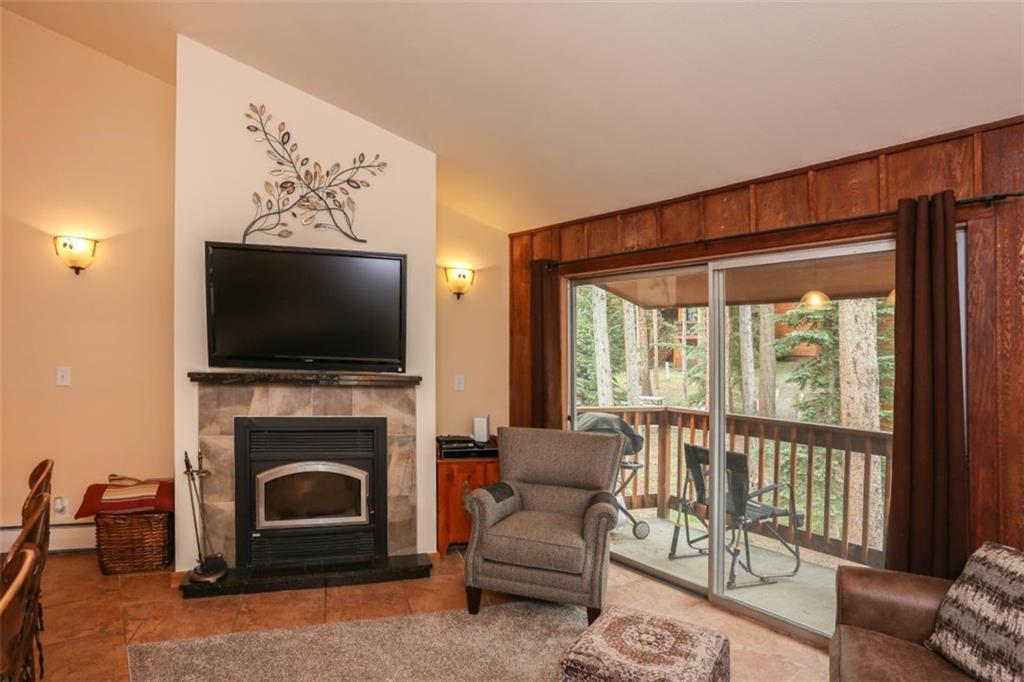 1080 Ski Hill Road, Unit 9 Breckenridge, CO 80424 - Photo 6 of 25 a living room with furniture a flat screen tv and a fireplace
