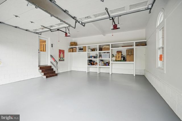 a kitchen with granite countertop a stove top oven microwave and cabinets