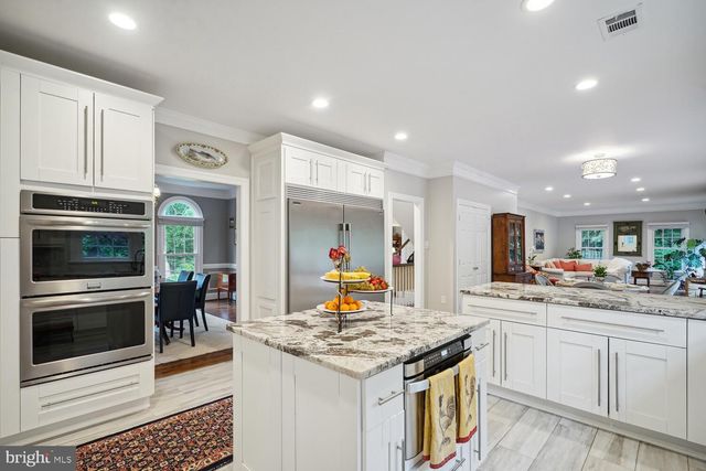 a kitchen with granite countertop a sink stove and refrigerator