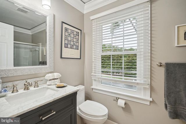 a spacious bedroom with a bed a mirror and lamp