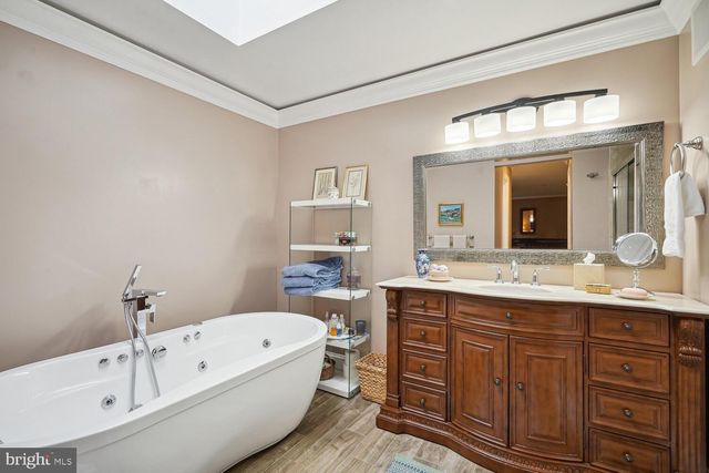 a spacious bathroom with a double vanity sink a toilet and a mirror