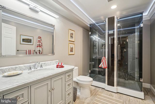 a view of a room with gym equipment and wooden floor
