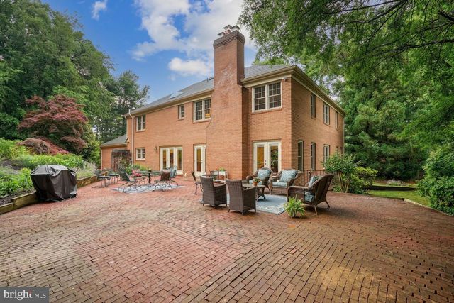 a backyard of a house with yard and outdoor seating