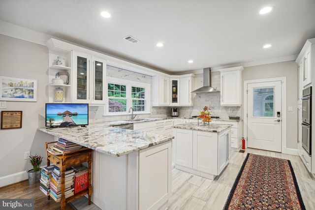a kitchen with sink stove and cabinets
