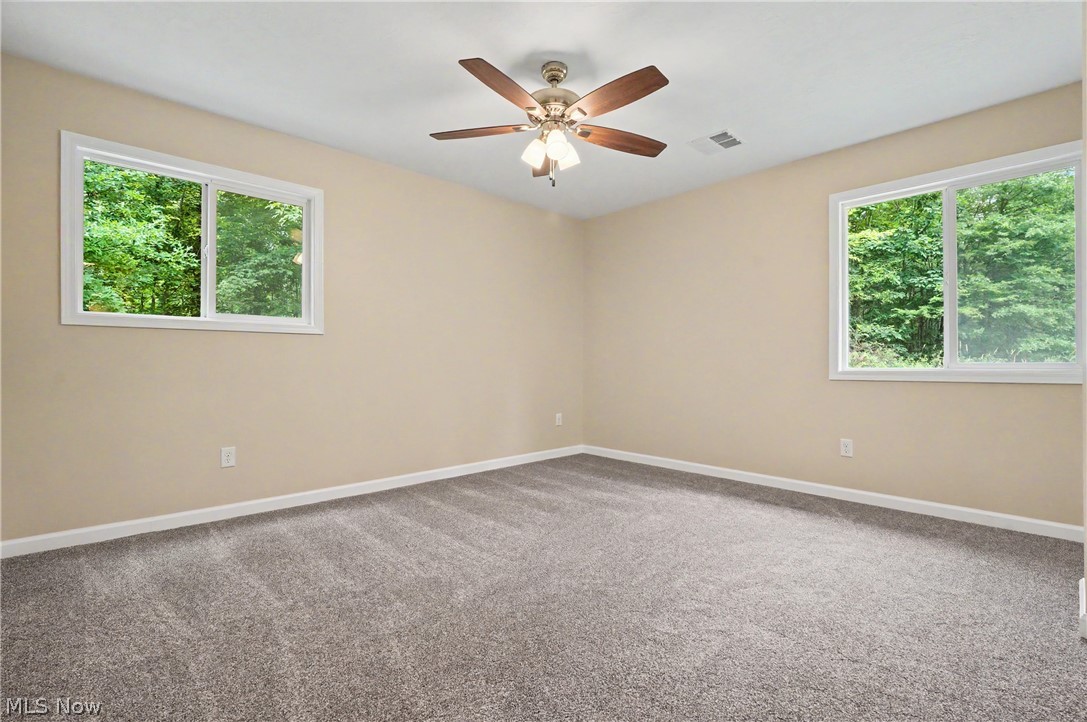 7583 Yale Road Atwater, OH 44201 - Photo 26 of 41 Another view of the primary bedroom. Lovely view of the backyard.