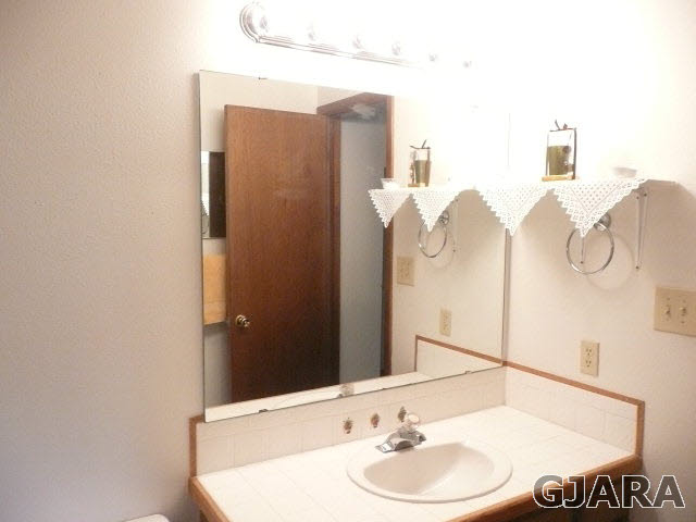 2721 Patterson Road, Unit 402 Grand Junction, CO 81506 - Photo 19 of 22 a bathroom with a sink and a mirror