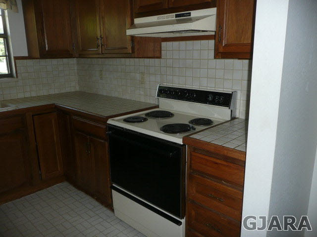 2721 Patterson Road, Unit 402 Grand Junction, CO 81506 - Photo 3 of 22 a kitchen with granite countertop stove top oven and cabinets