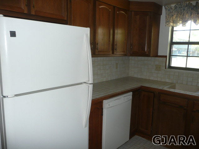 2721 Patterson Road, Unit 402 Grand Junction, CO 81506 - Photo 4 of 22 a kitchen with a refrigerator and a window