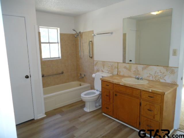 16994-c R 223 C R 223 Arp, TX 75750 - Photo 28 of 38 a bathroom with a granite countertop toilet a sink and bathtub