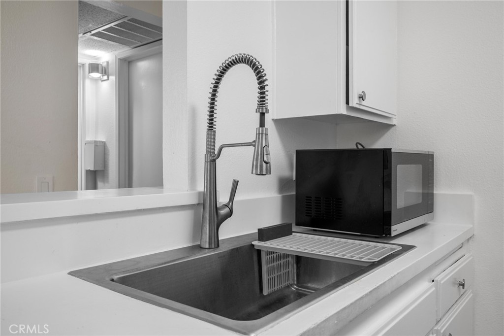 15425 Sherman Way, Unit 107A Van Nuys, CA 91406 - Photo 11 of 23 a kitchen with a sink and a microwave