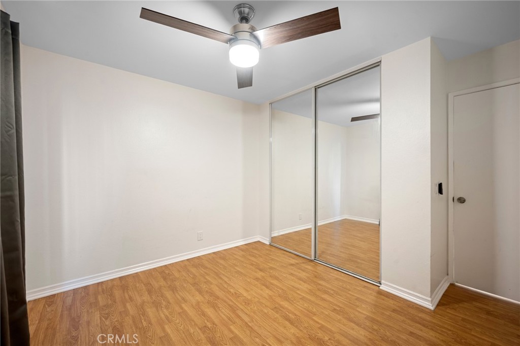 15425 Sherman Way, Unit 107A Van Nuys, CA 91406 - Photo 16 of 23 a view of empty room with wooden floor and fan