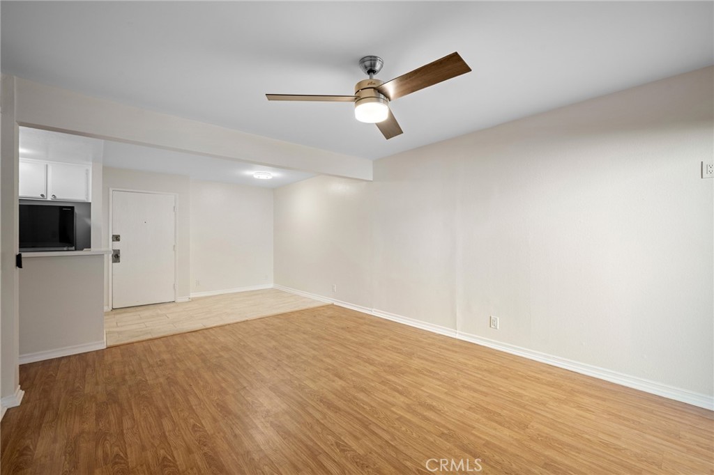 15425 Sherman Way, Unit 107A Van Nuys, CA 91406 - Photo 5 of 23 an empty room with wooden floor and windows