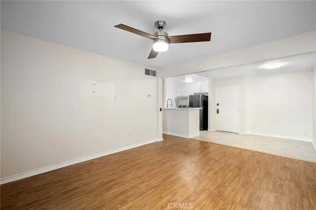 a view of a kitchen with a sink and a refrigerator