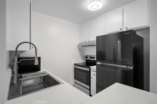 a kitchen with a refrigerator and cabinets