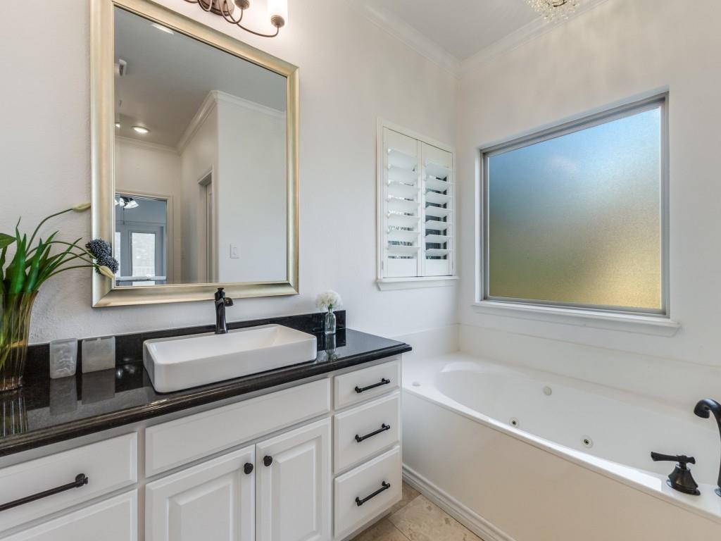 5848 Lago Vista Athens, TX 75752 - Photo 12 of 33 a bathroom with a granite countertop sink a mirror a and a bathtub