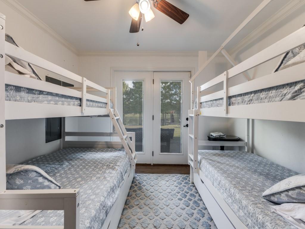 5848 Lago Vista Athens, TX 75752 - Photo 18 of 33 a large bedroom with a bed and glass door