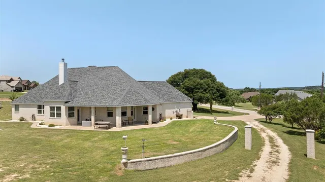 a swimming pool with outdoor seating and yard