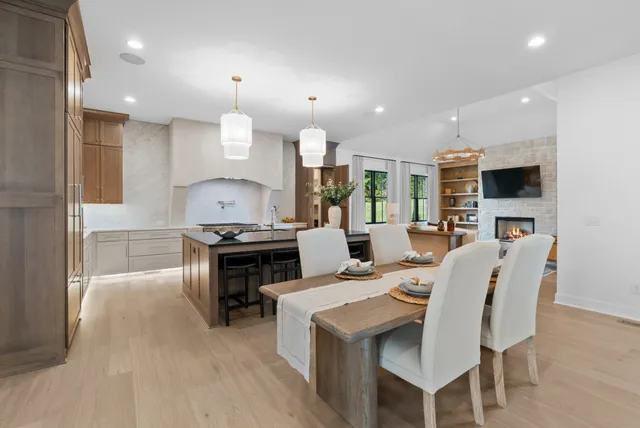 a living room with furniture a fireplace and a large window