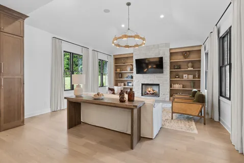 a living room with furniture fireplace and window